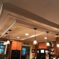 Warm restaurant interior with hanging pendant lights and wood-paneled ceiling