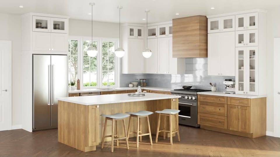 Bright modern kitchen with wooden island, white cabinets, stainless fridge, and two stools