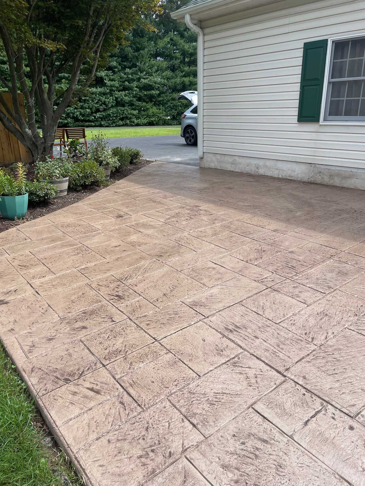 a stamped concrete patio at the back of the house