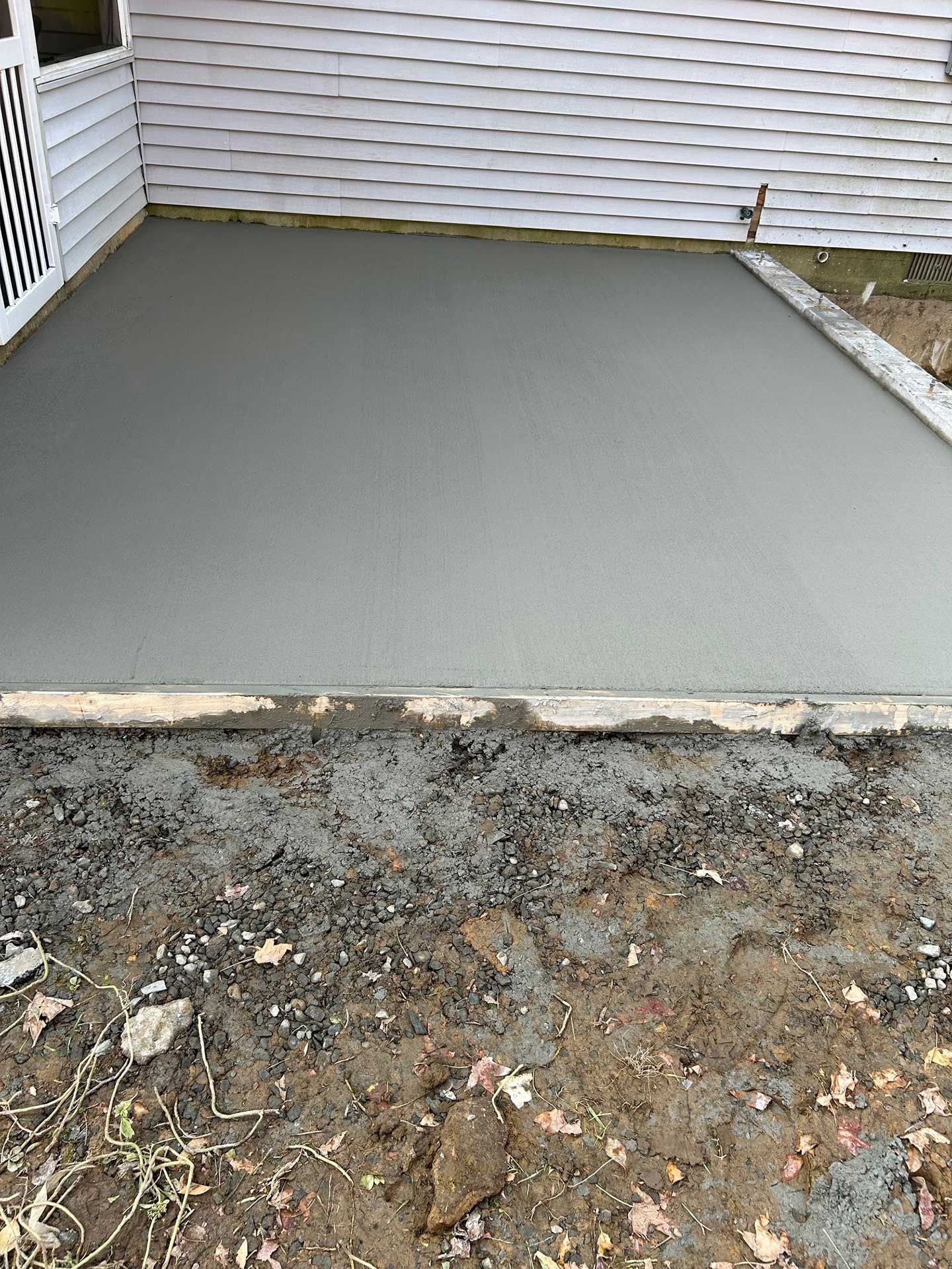 a concrete slab is being built in front of a house