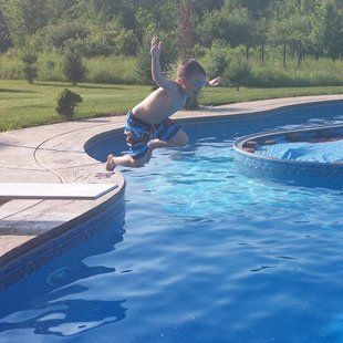 Boy Jumping in Swimming Pool