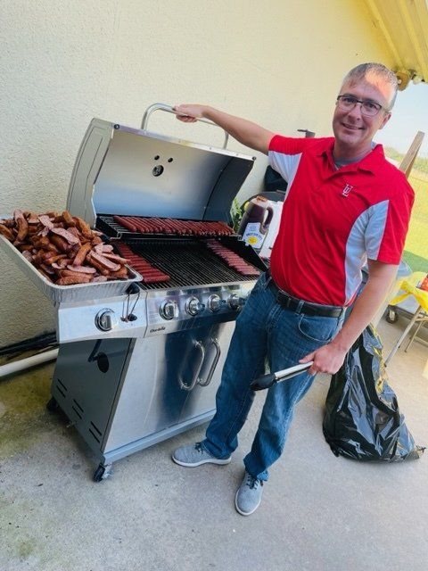 man cooking on barbecue grill