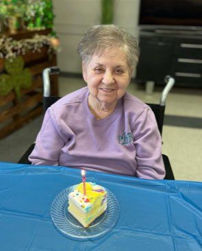 woman sitting in front of cake