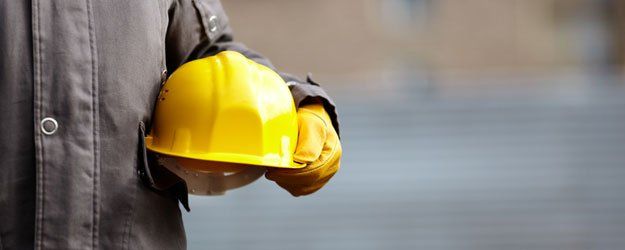 a worker holding a hard hat