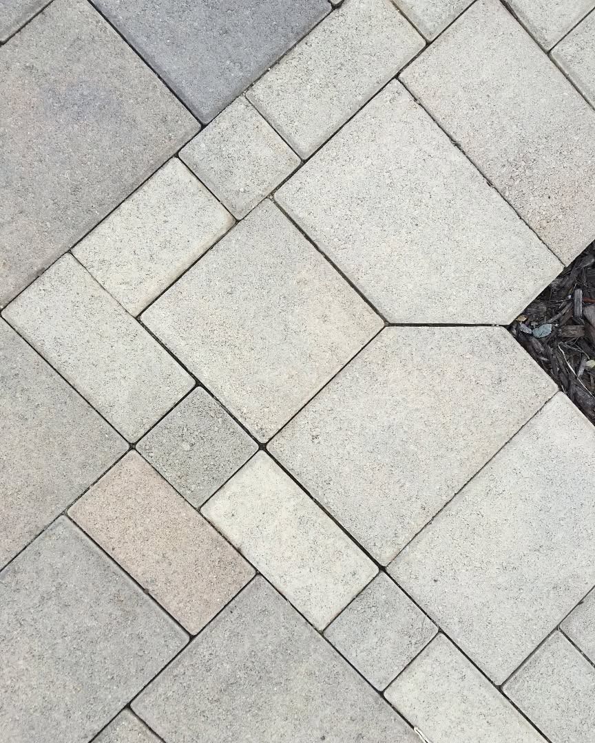 Light gray stone pavers laid in a diagonal pattern with a small dark gap at the edge
