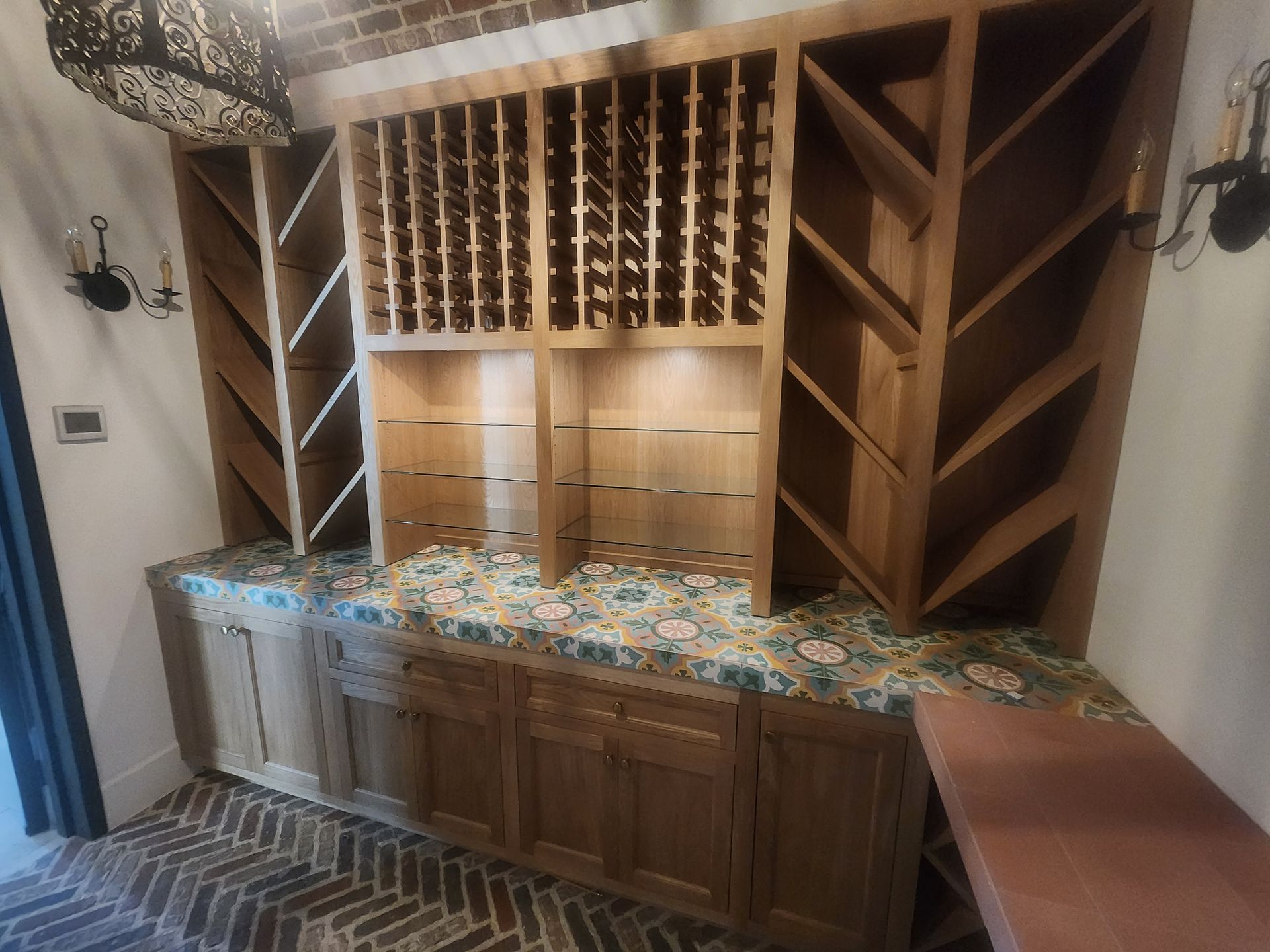 Built-in cabinet with a mini-fridge, microwave, and storage. Light wood with a dark trim, set against a neutral wall and carpet.