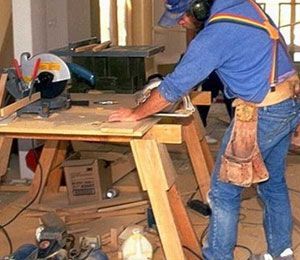 man running a table saw