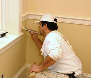 man painting interior wall