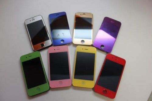 A group of colorful cell phones are lined up on a table