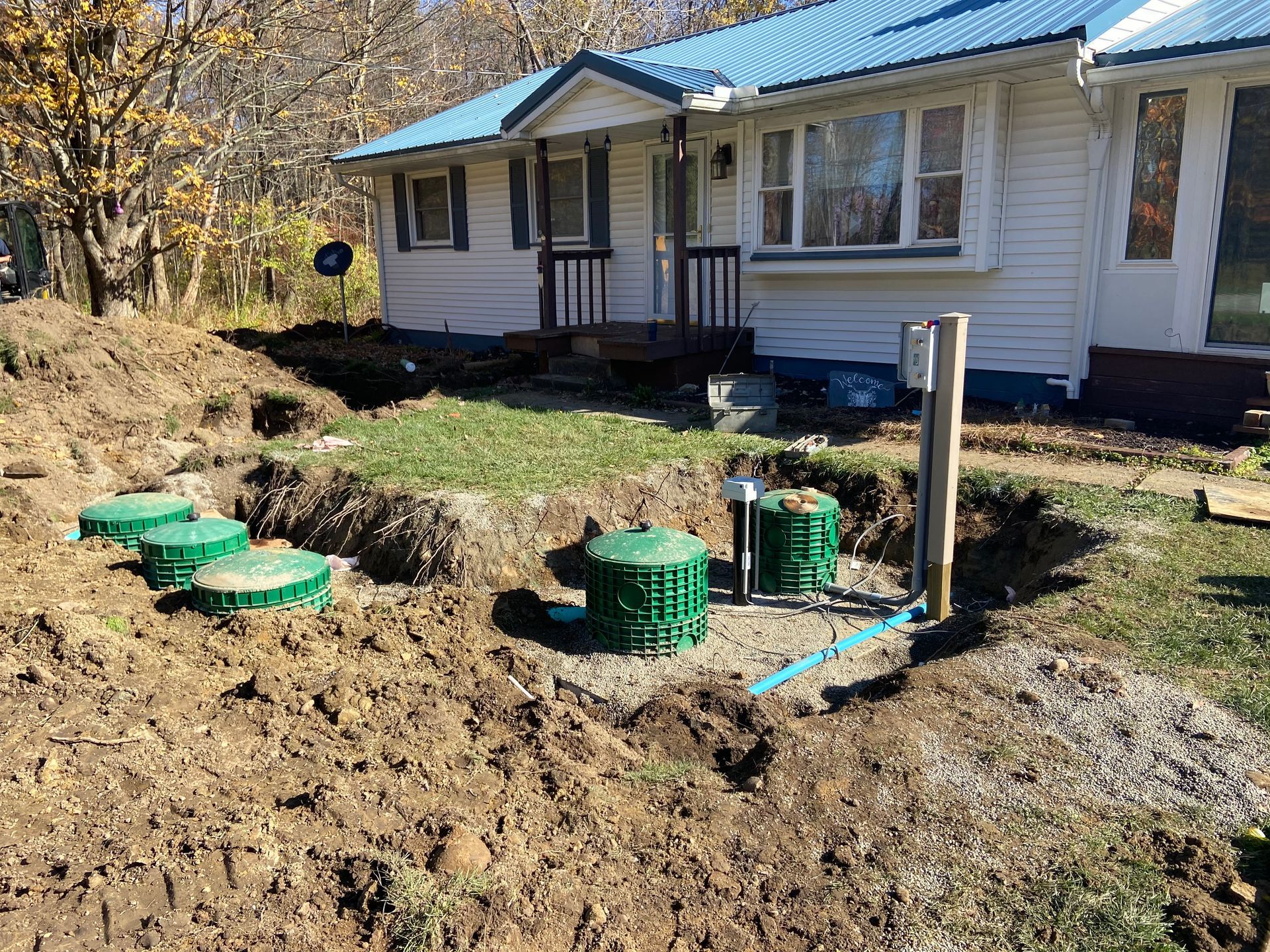 A septic system is being installed in front of a house