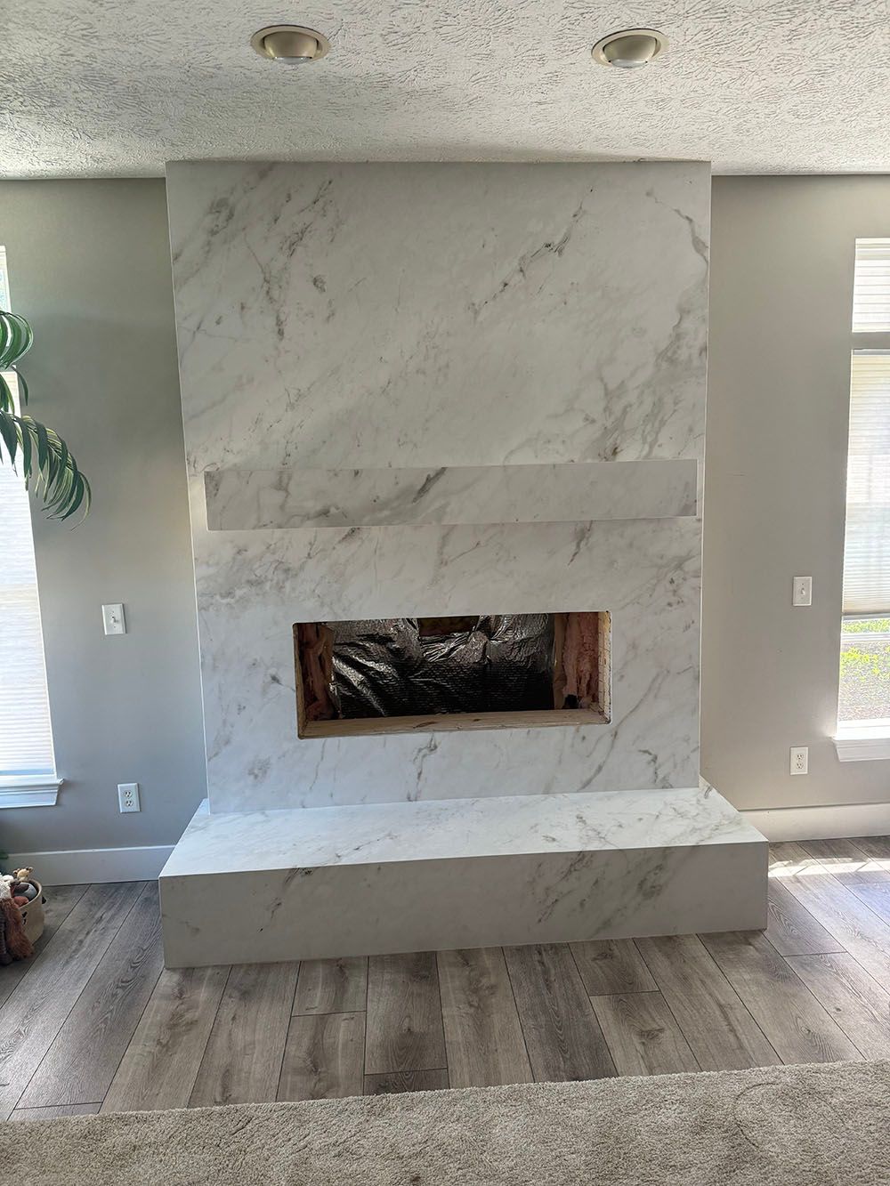 There is a fireplace in the middle of the room.