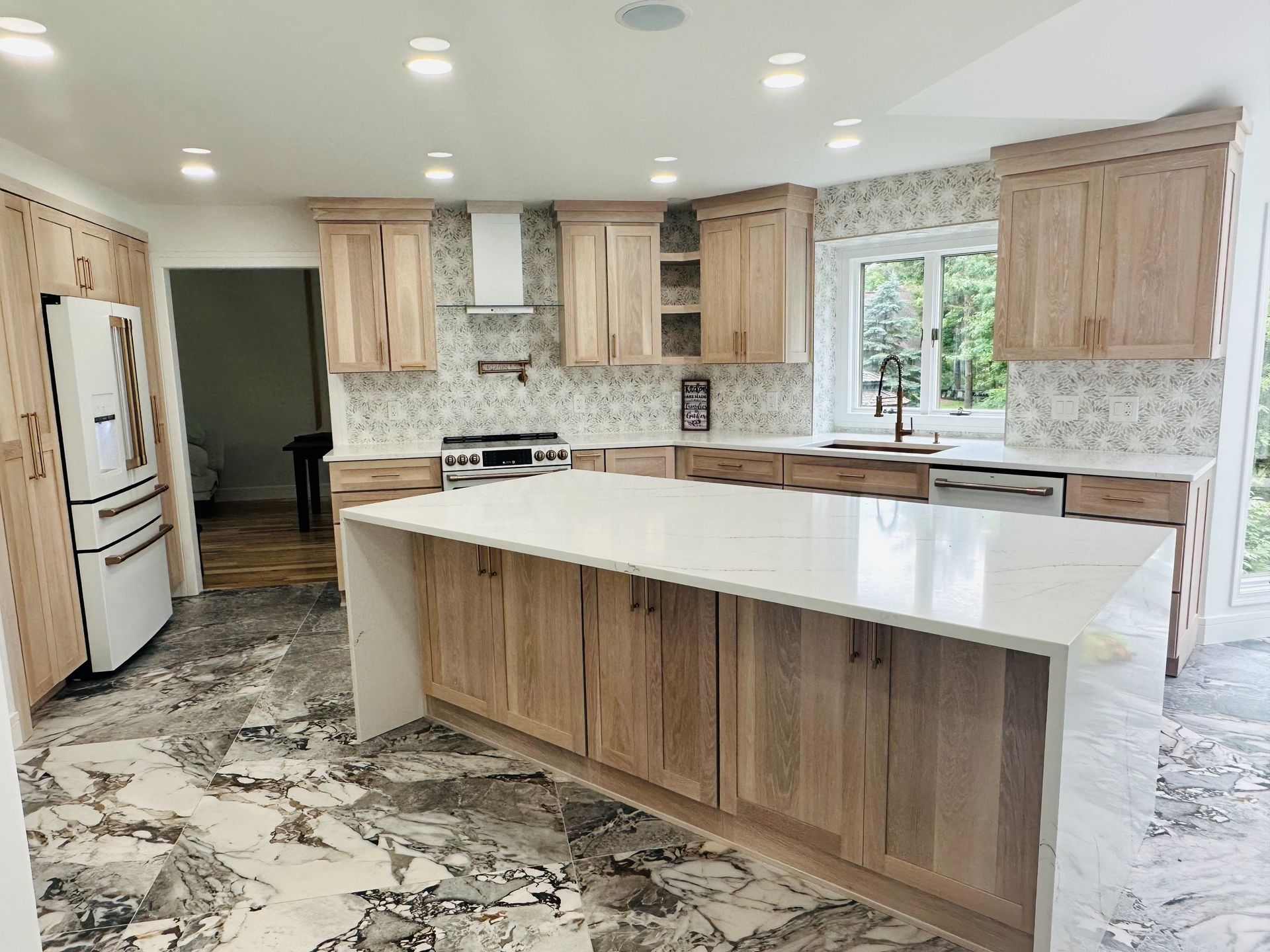 A kitchen with wooden cabinets and white counter tops.