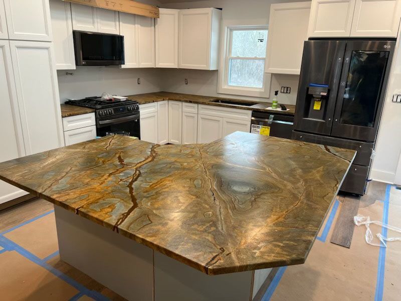 A kitchen with a large island in the middle of it.