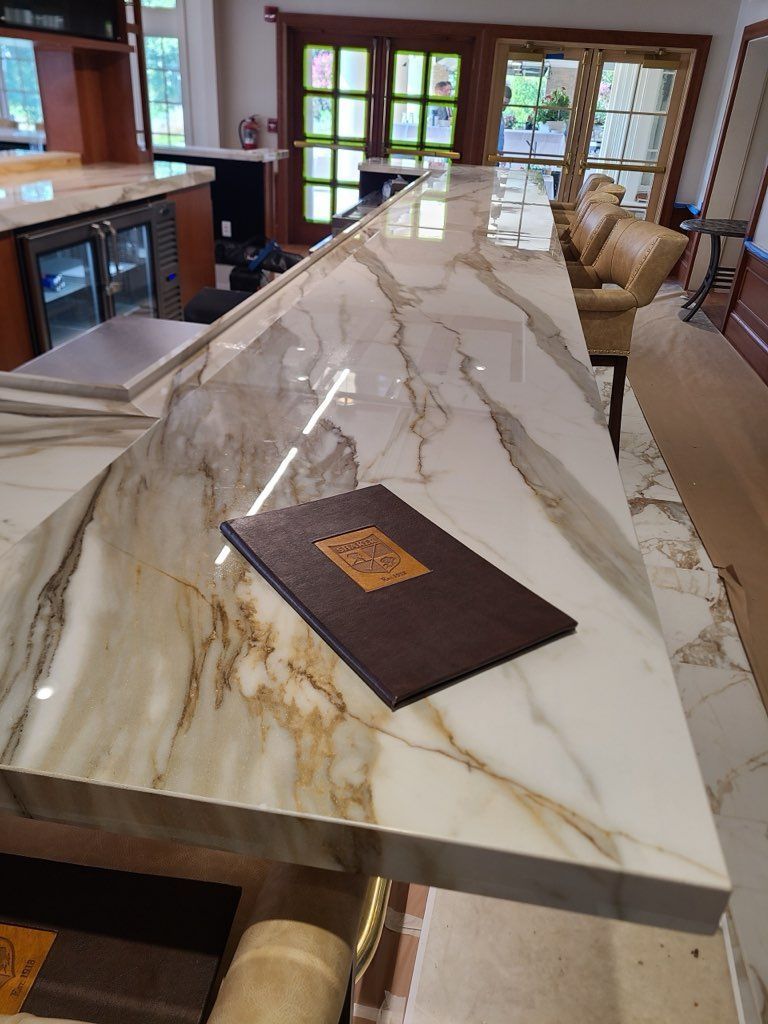 Marble countertop bar with a menu, indoor setting.
