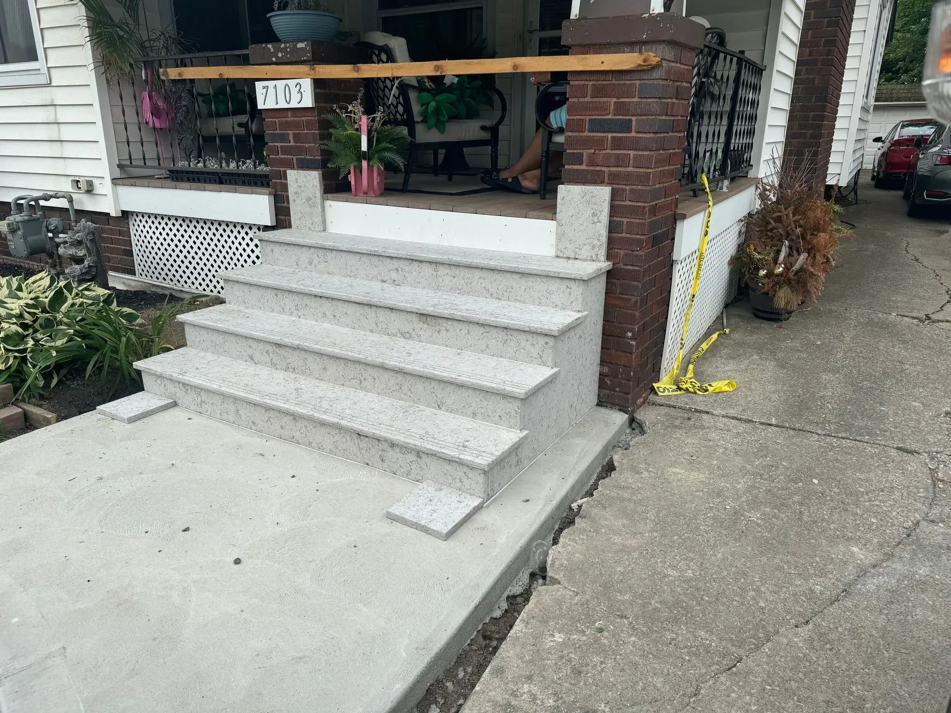 A set of stairs leading up to a porch of a house.