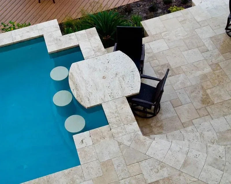 An aerial view of a swimming pool with a table and chairs.