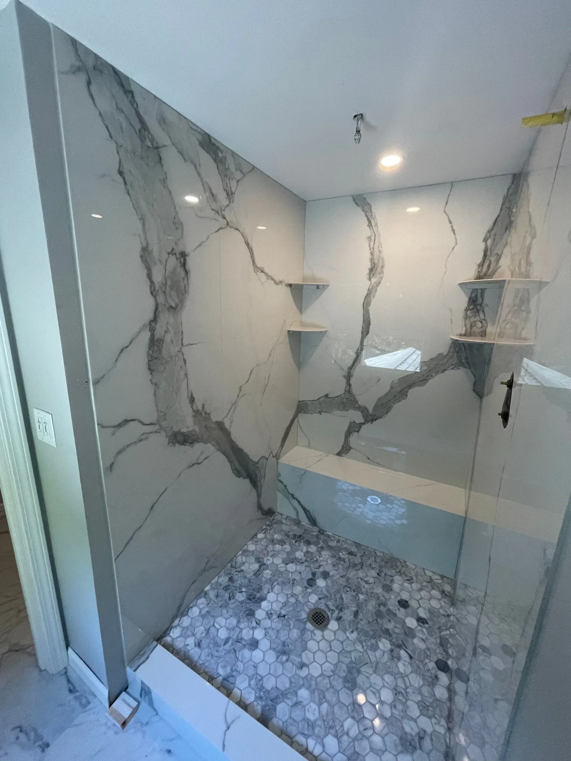 A bathroom with a walk in shower and a bathtub.