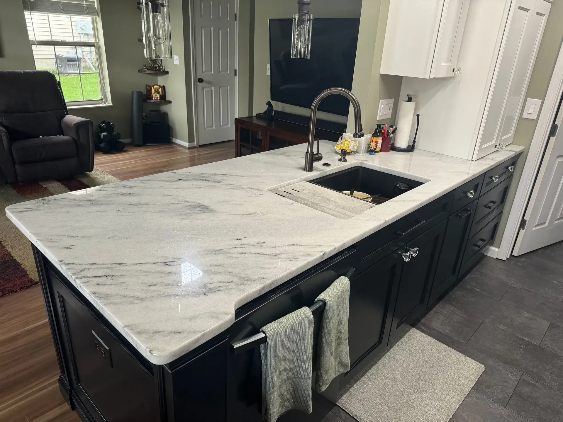 A kitchen with a large island and a sink.