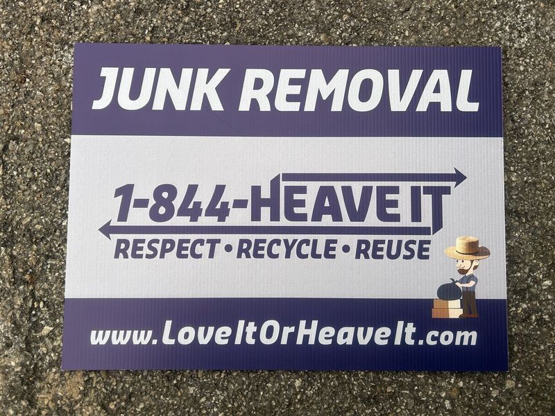 Sign advertising junk removal services; purple and white; contact information included.
