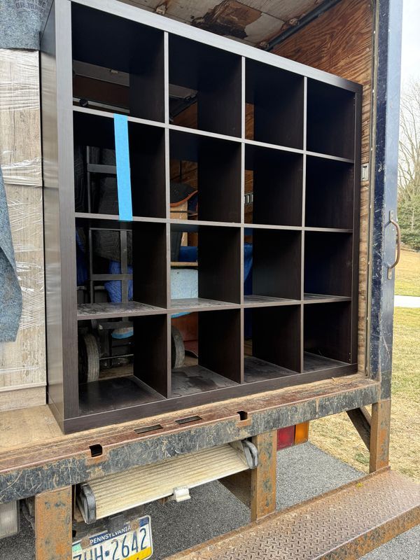 Dark brown cube shelf loaded in the back of a truck, ready for transport.