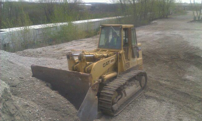 Yellow Caterpillar bulldozer on a gravel surface.