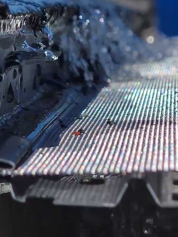 A close up of a piece of metal with a lot of lines on it.