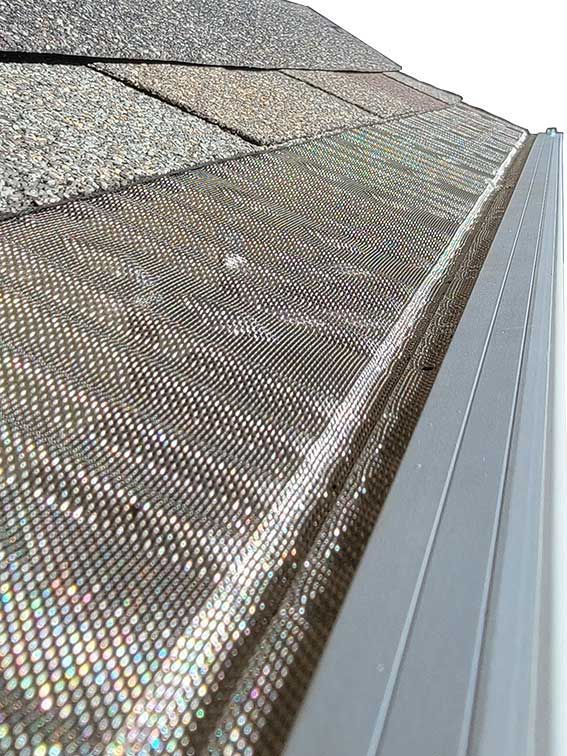 A close up of a gutter guard on a roof.