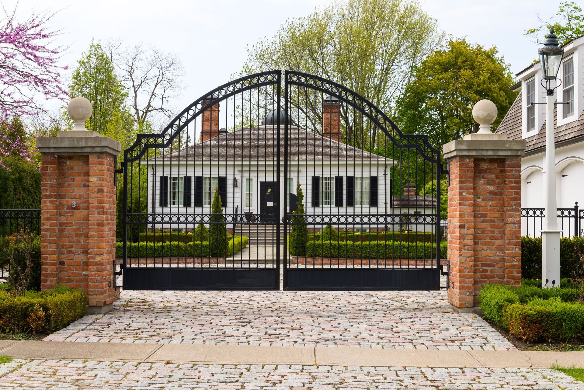 There is a large gate in front of a house.