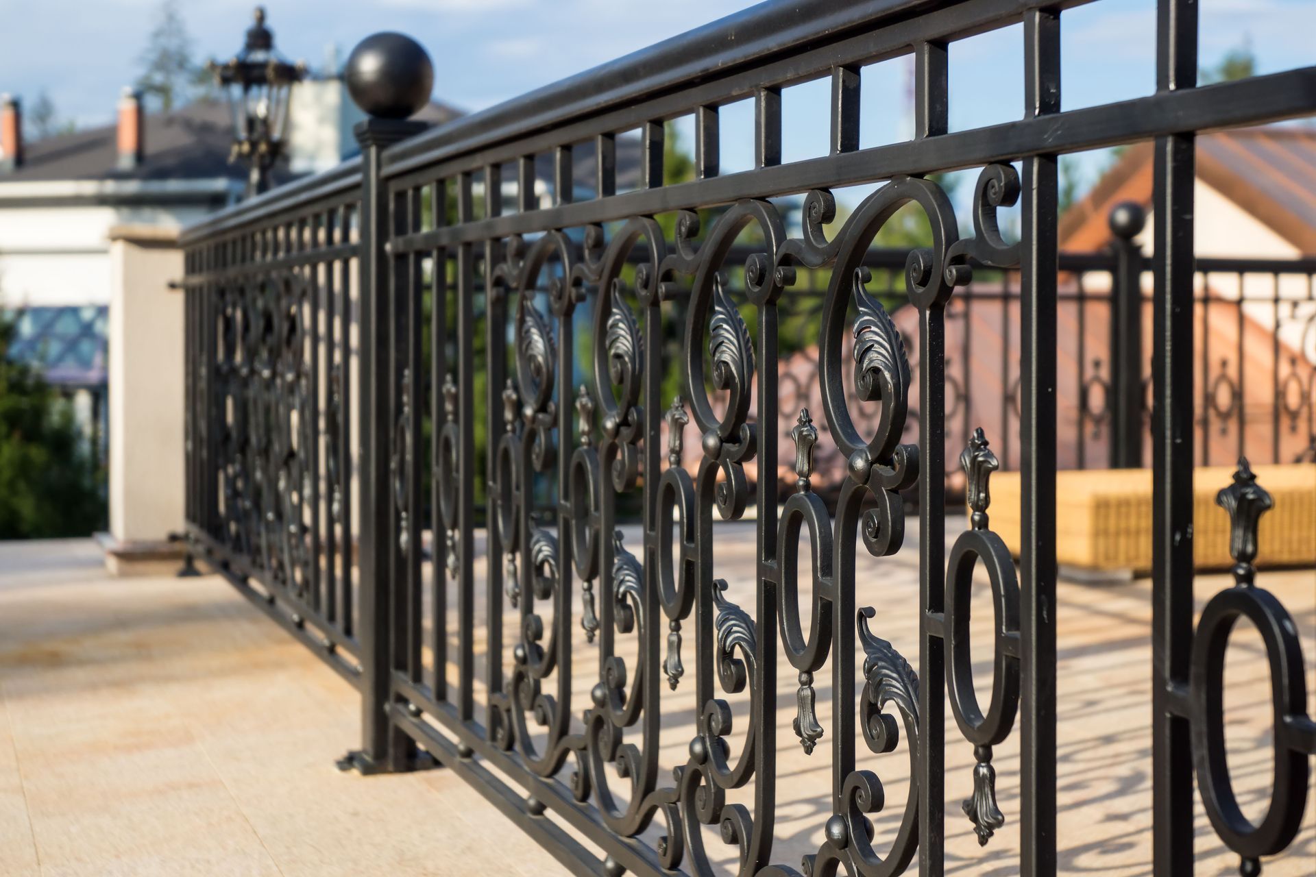 A close-up of a wrought iron fence on a balcony.