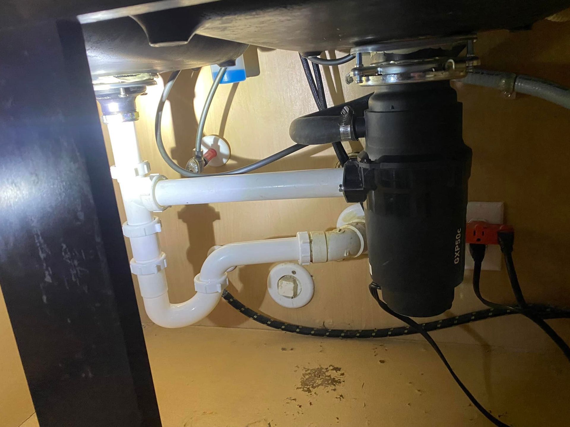 A sink with a garbage disposal underneath it.