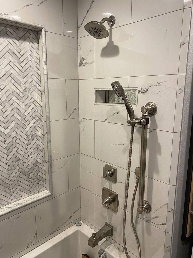 A bathroom with a shower , tub , and shower head.