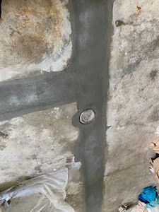 A close up of a concrete wall with a hole in it.