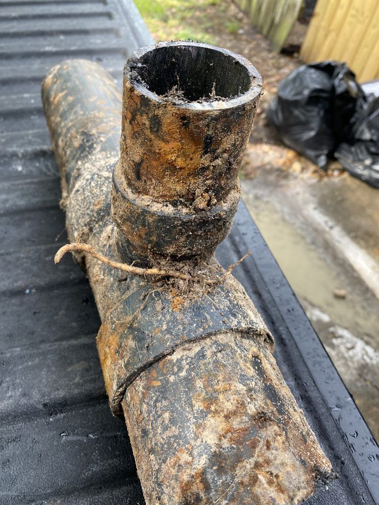 A close up of a rusty pipe sitting on top of a truck bed.