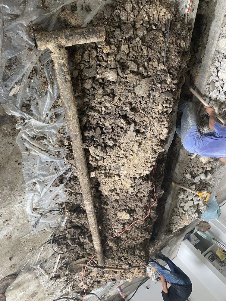 A man is digging a hole in the ground with a shovel.