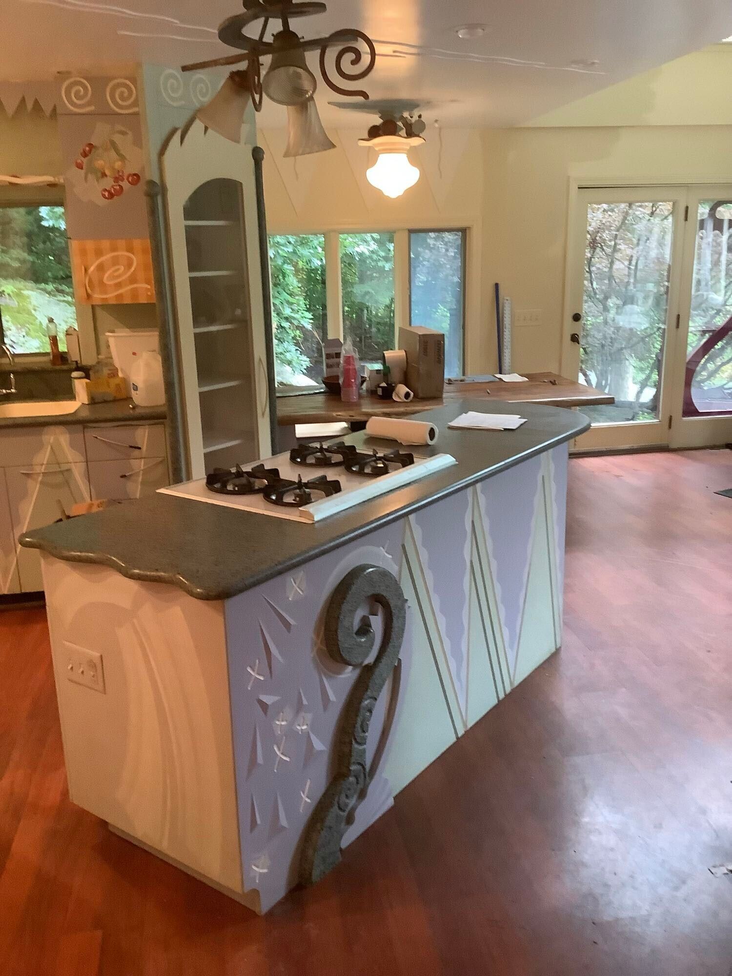 A kitchen with a large island and a stove top oven.