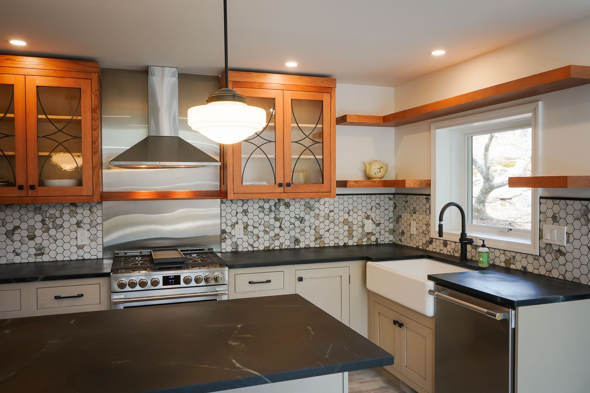 A kitchen with stainless steel appliances and wooden cabinets