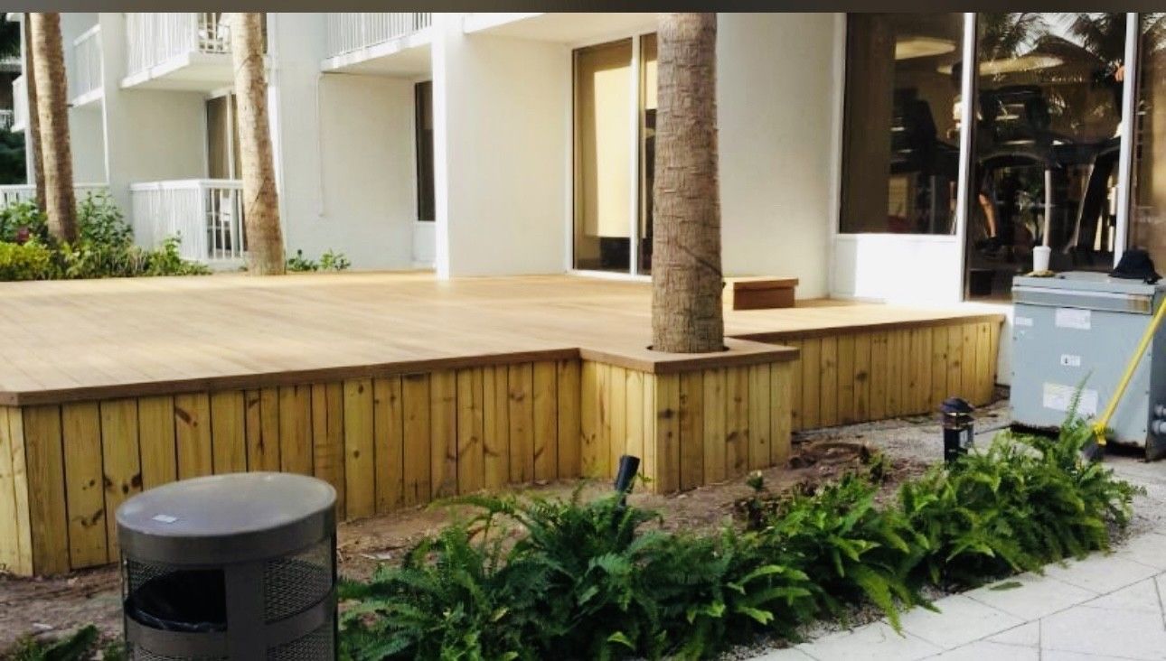 A wooden deck is being built in front of a building.