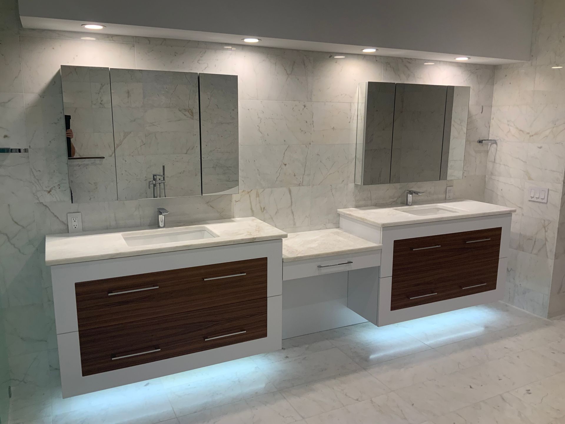 A bathroom with two sinks and two mirrors.