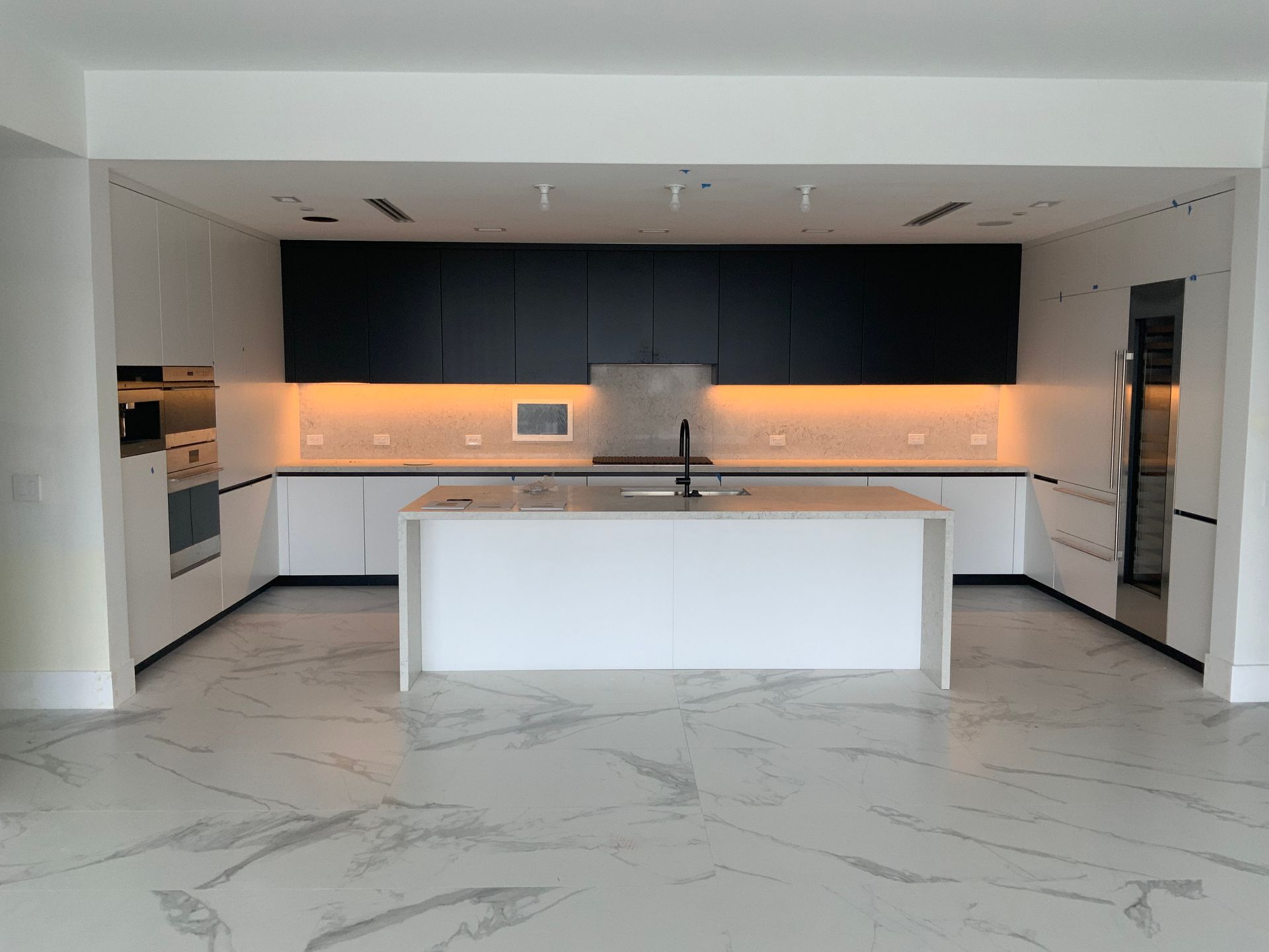 A kitchen with a large island in the middle of it