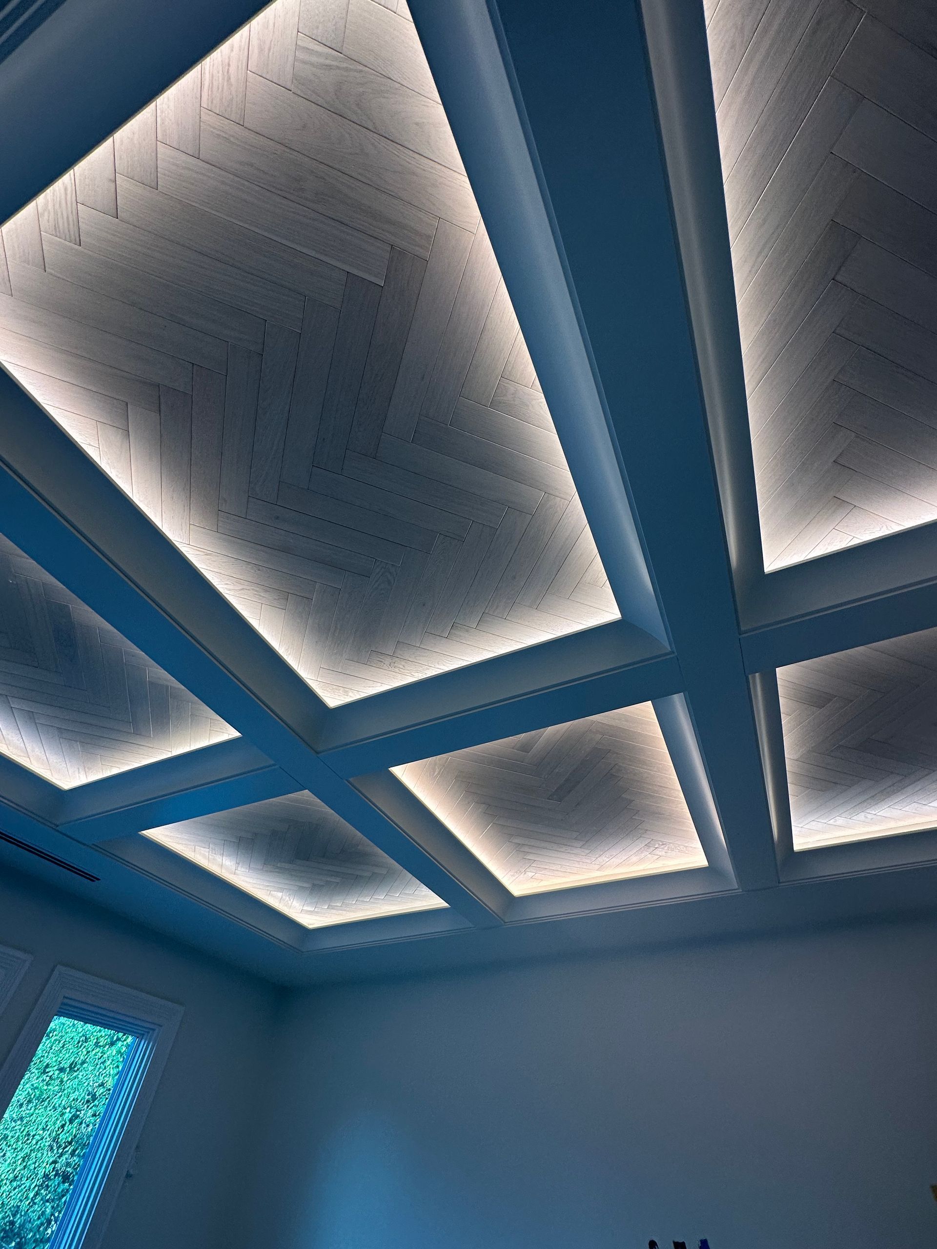 A room with a blue ceiling and a window