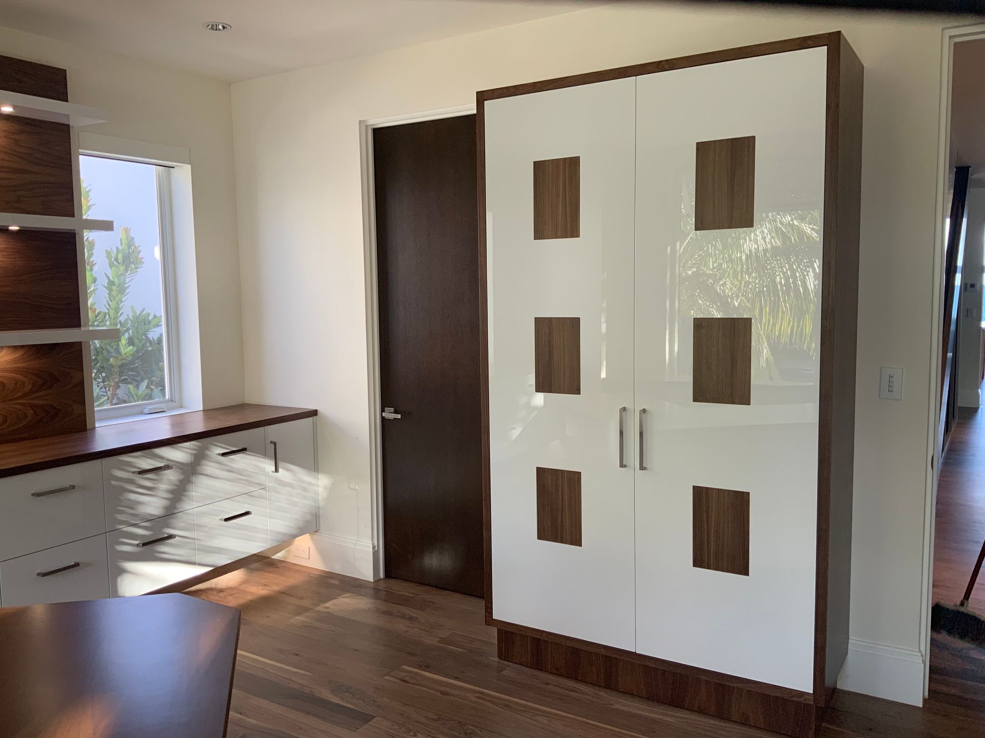 A room with a wardrobe and a desk in it