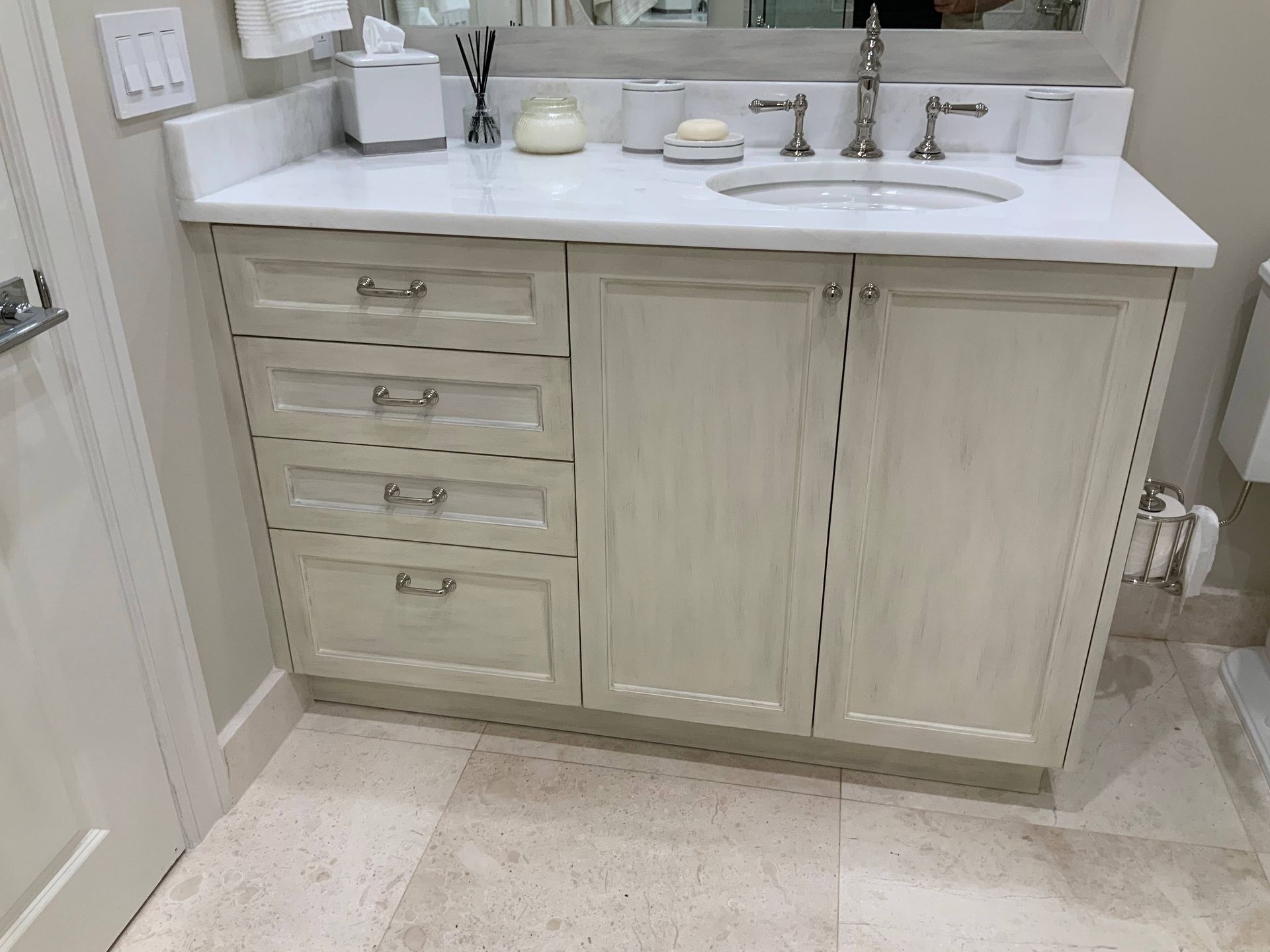 A bathroom vanity with a sink , mirror and drawers.