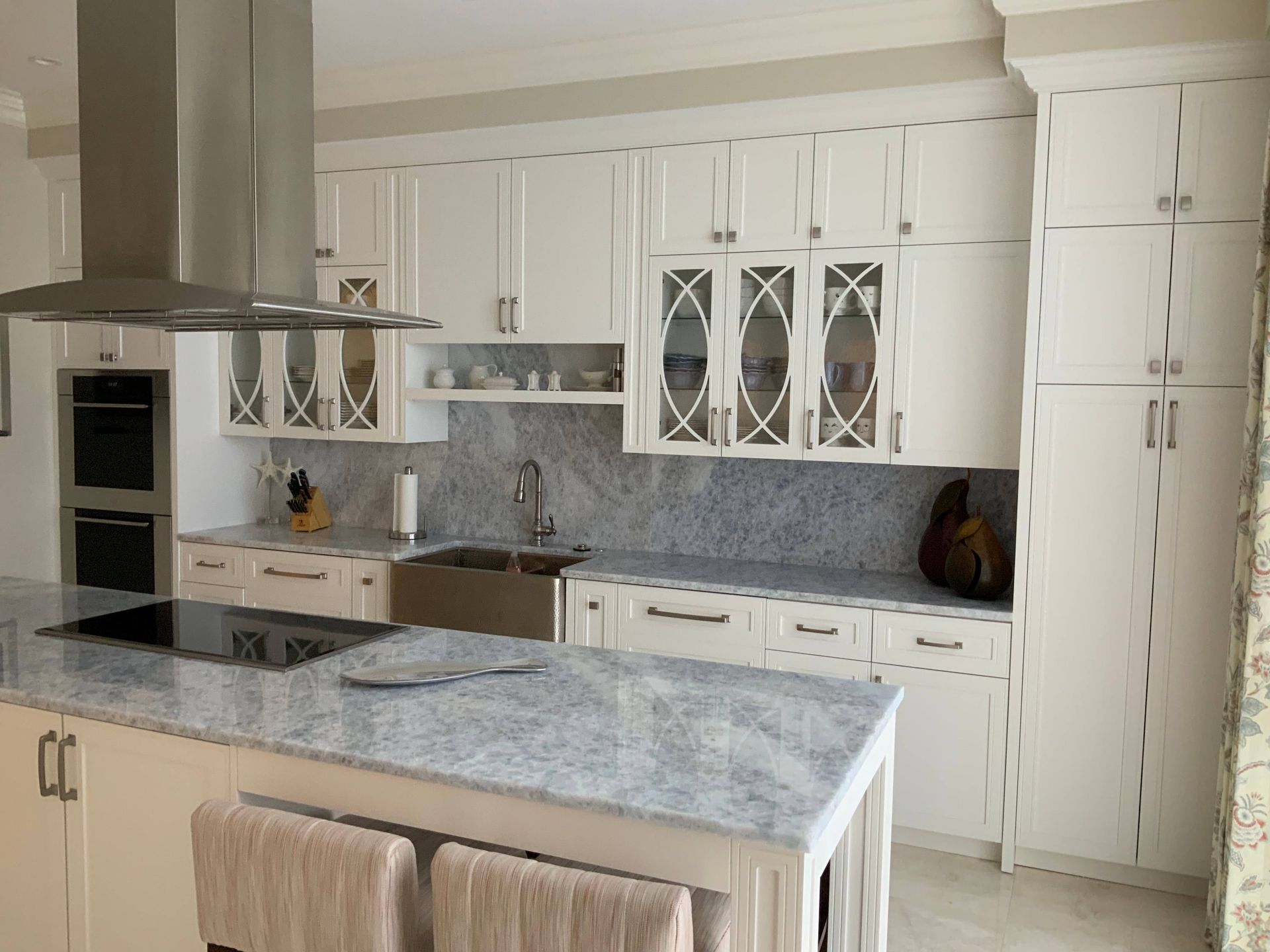 A kitchen with white cabinets and granite counter tops