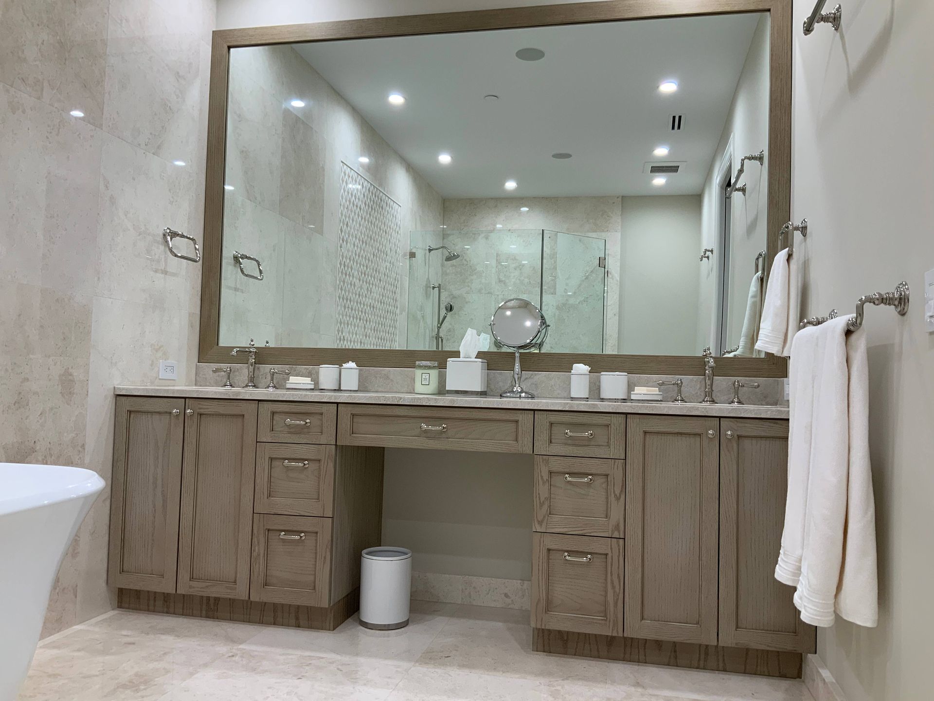 A bathroom with two sinks and a large mirror.