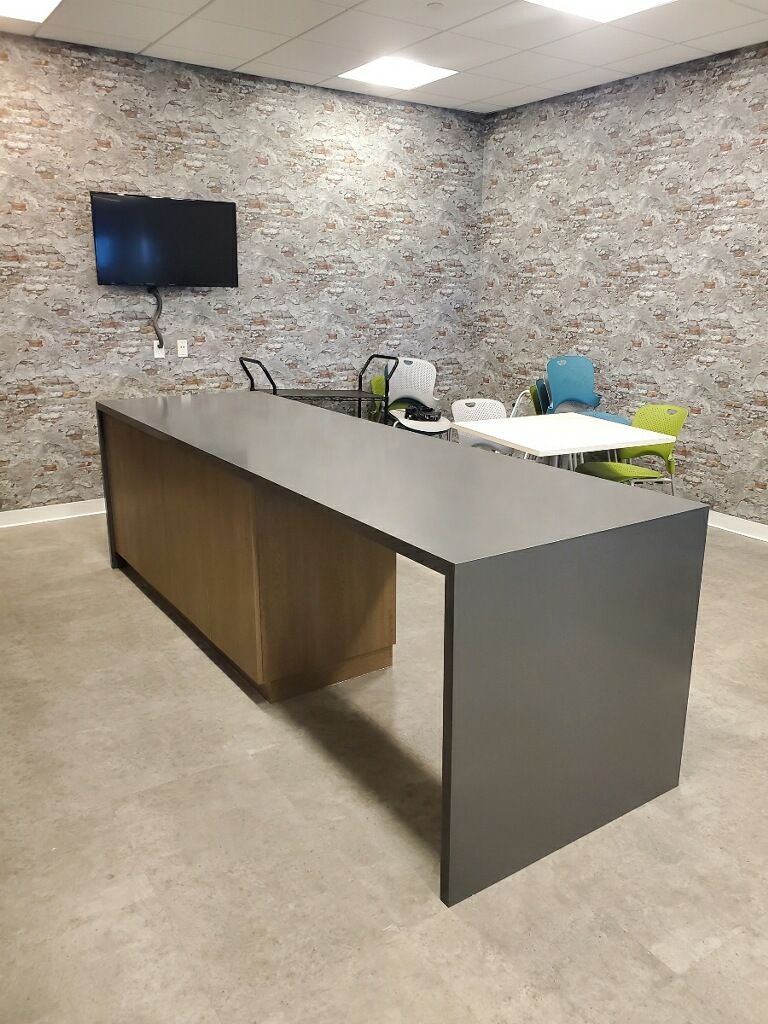 There is a long table in the middle of the room.