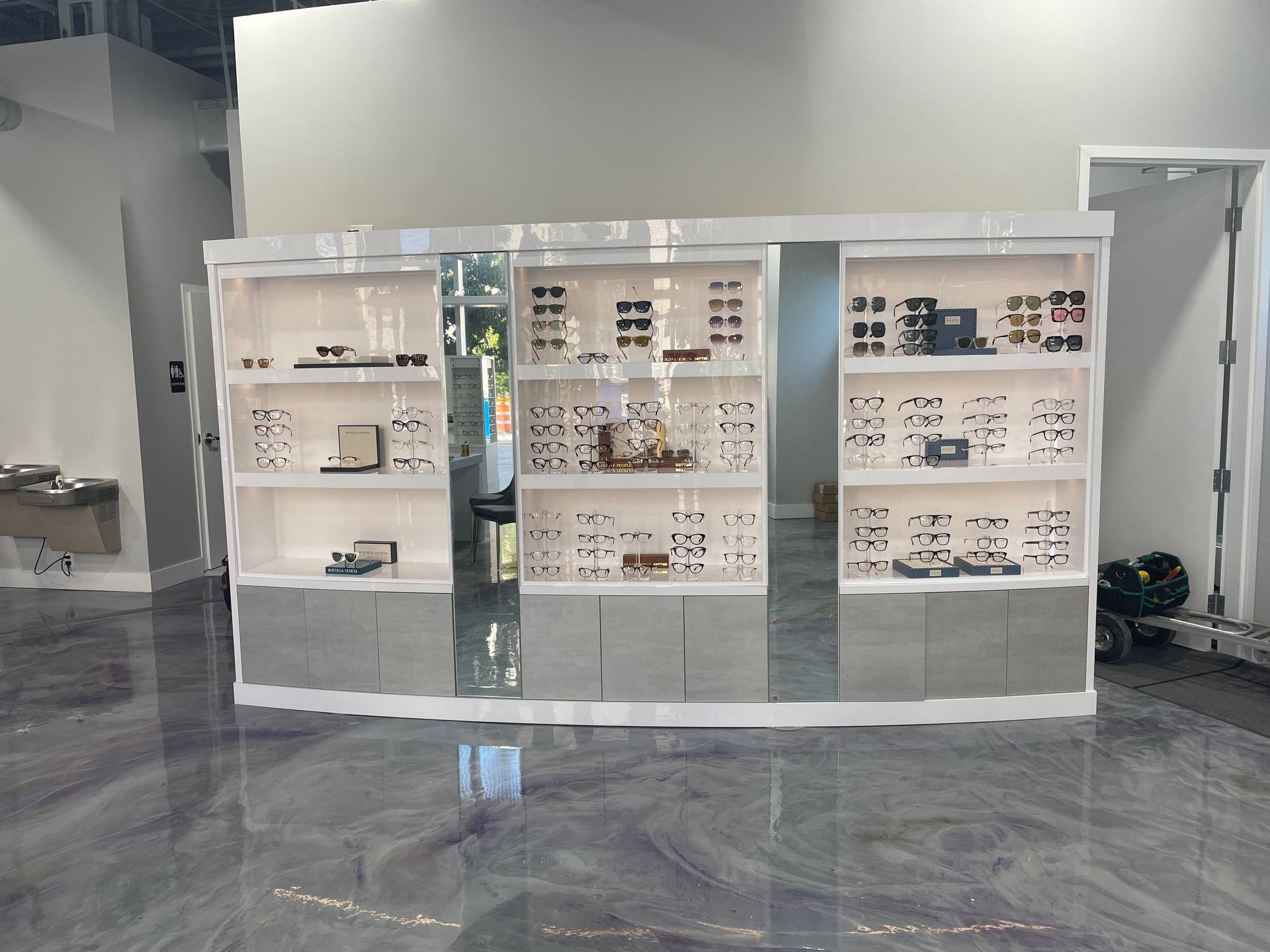 A room with a lot of shelves and a mirror