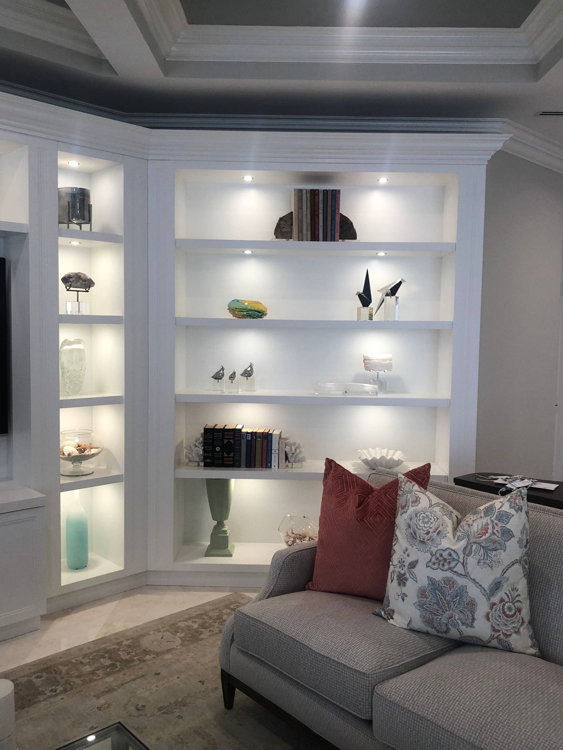 A living room with a couch and lots of shelves