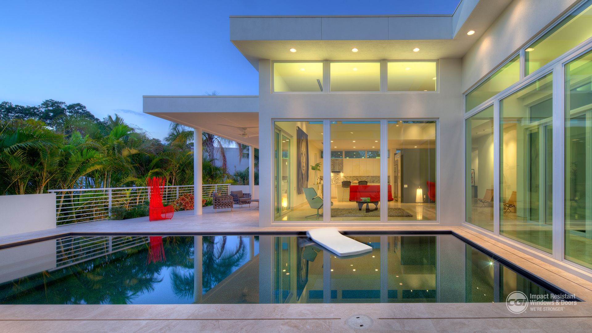 A house with a large swimming pool in front of it