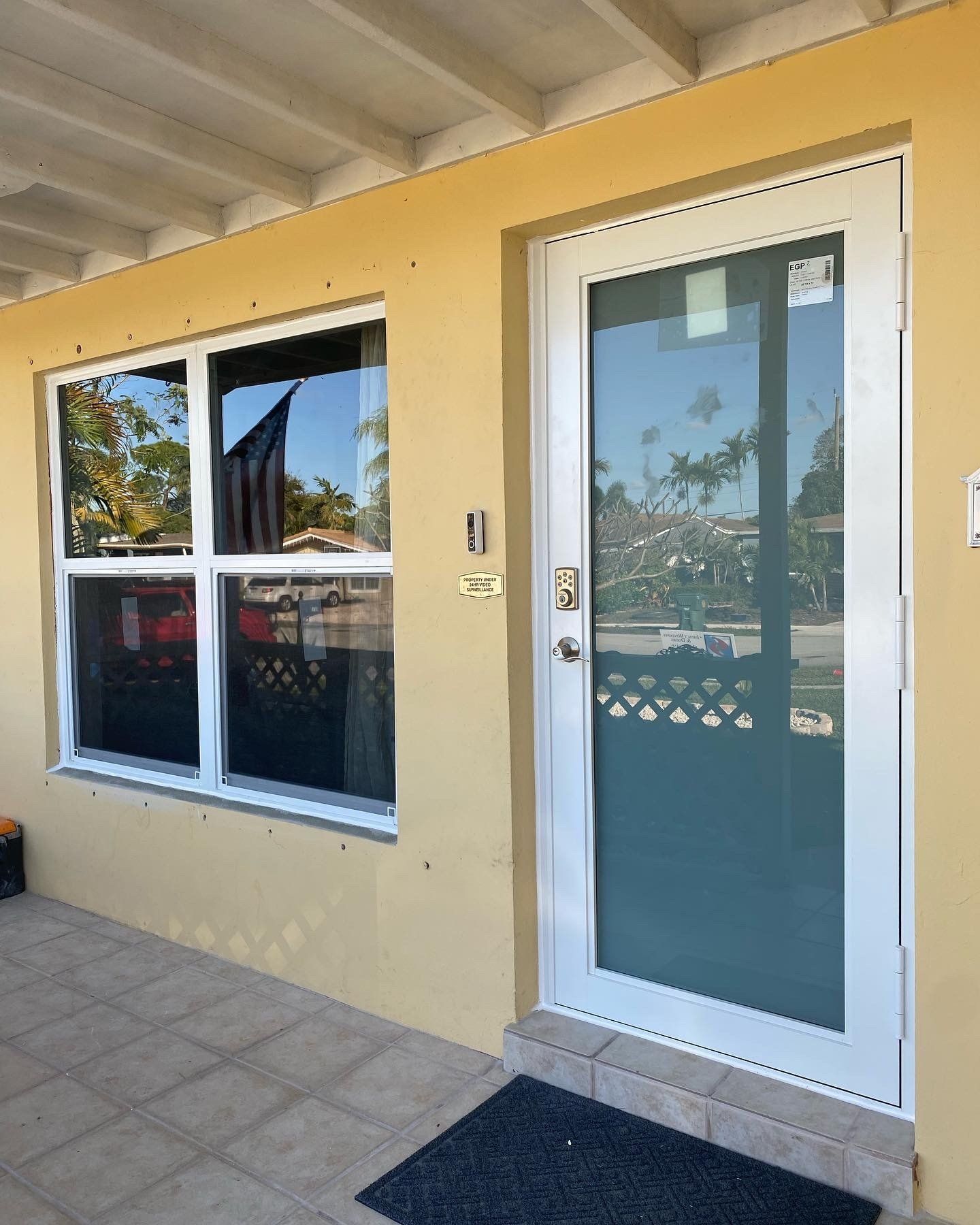 A yellow building with a white door and a window