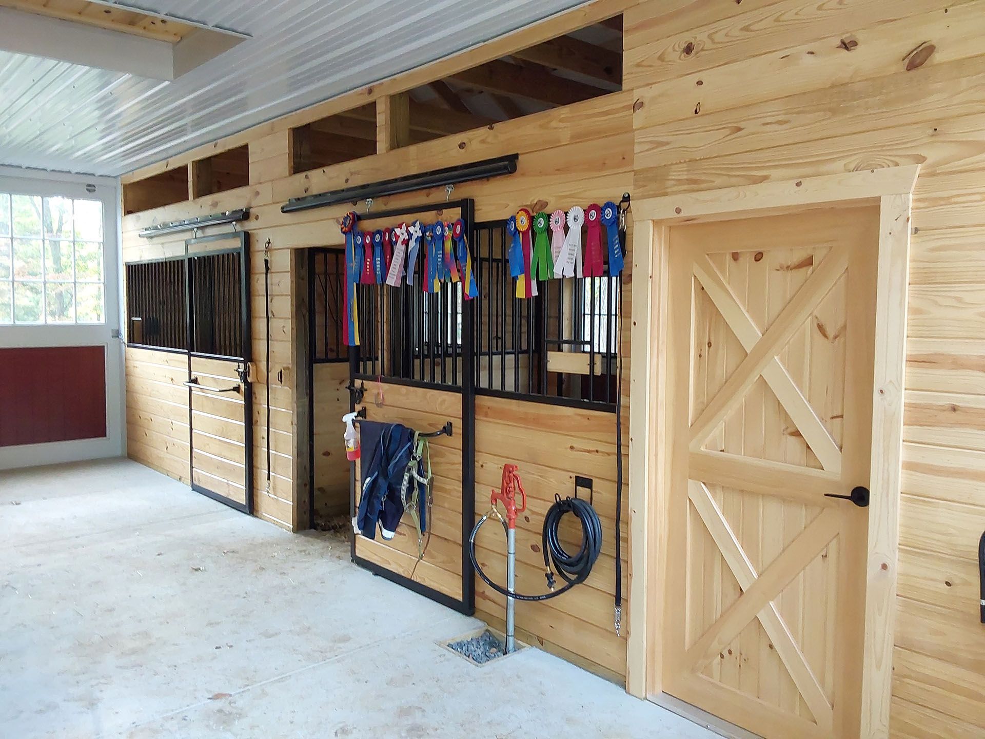 A horse stable with wooden walls and doors.